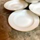 9 hollow plates in white and golden Limoges porcelain