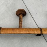Old rustic wooden coat rack turned in imitation of bamboo