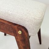 Pair of wooden stools with beige fabric.