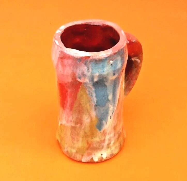 Traditional ceramic mug with a marbled glaze effect.