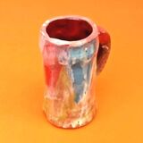 Traditional ceramic mug with a marbled glaze effect.