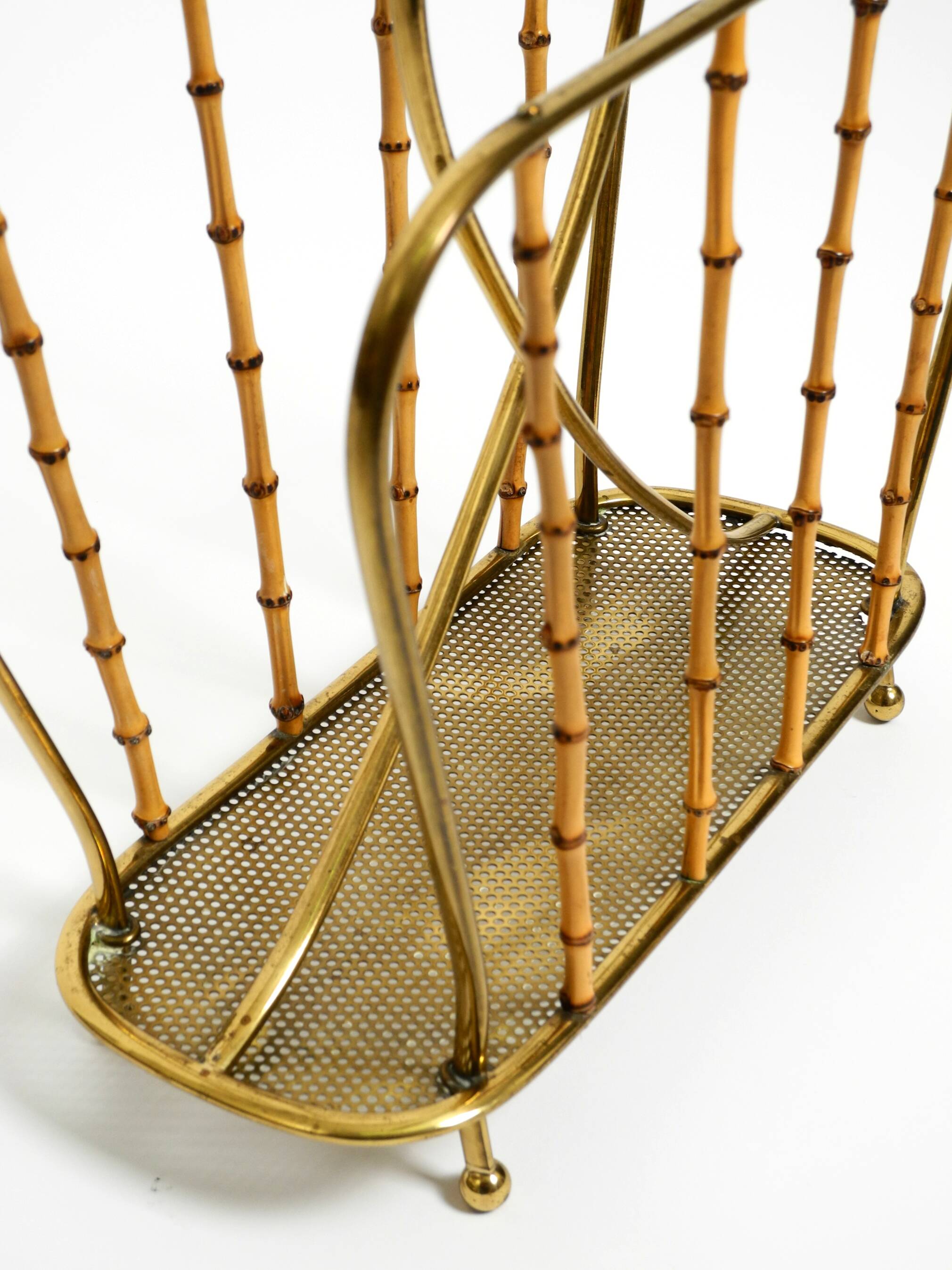Rare Mid Century Modern magazine rack made of solid brass and genuine bambo