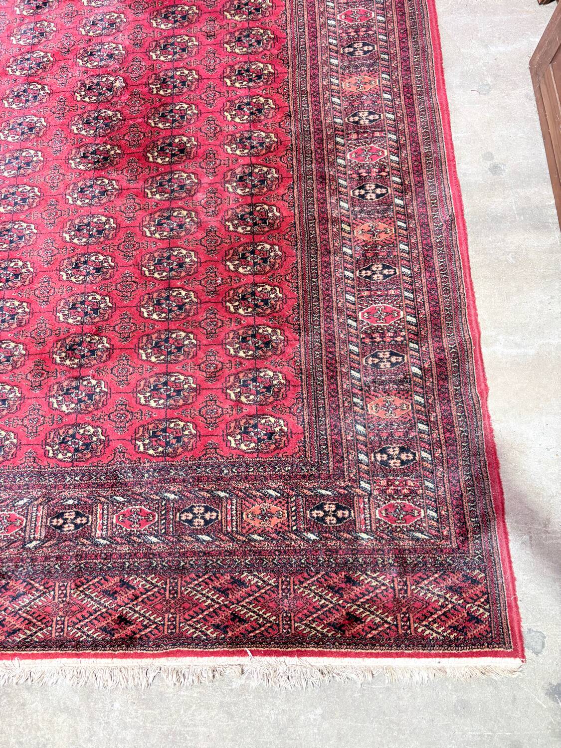 Large red Bokhara-style oriental carpet 300x200 cm with gul patterns.
