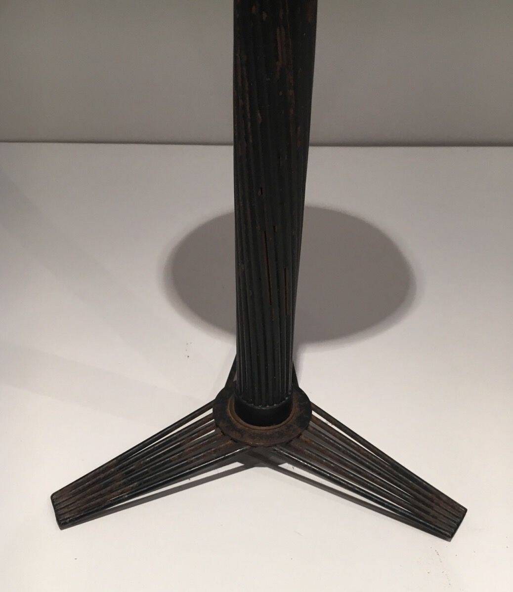 Brass ashtray on a stand made of black lacquered metal wire.