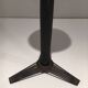 Brass ashtray on a stand made of black lacquered metal wire.