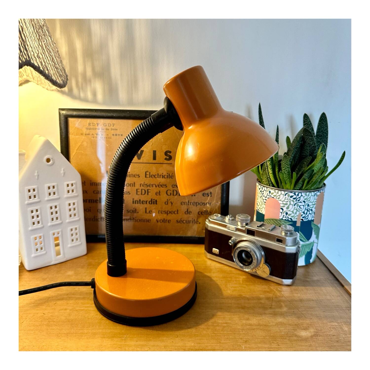Orange articulated desk lamp