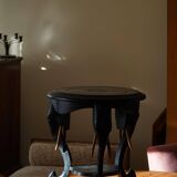 Side table in hardwood ebony with three elephant head-shaped legs, Eastern India, 1920s.