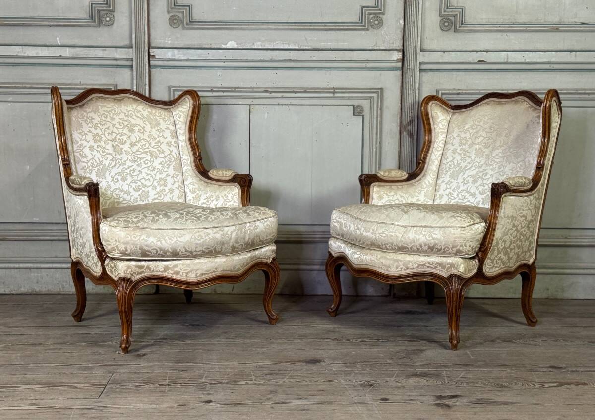 Pair of small Louis XV style wing chairs in carved walnut, Bosson stamp