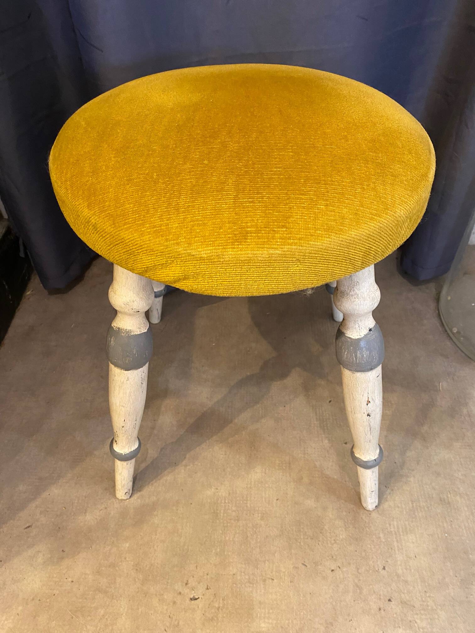 Old stool early 20th century wooden legs and round padded seat