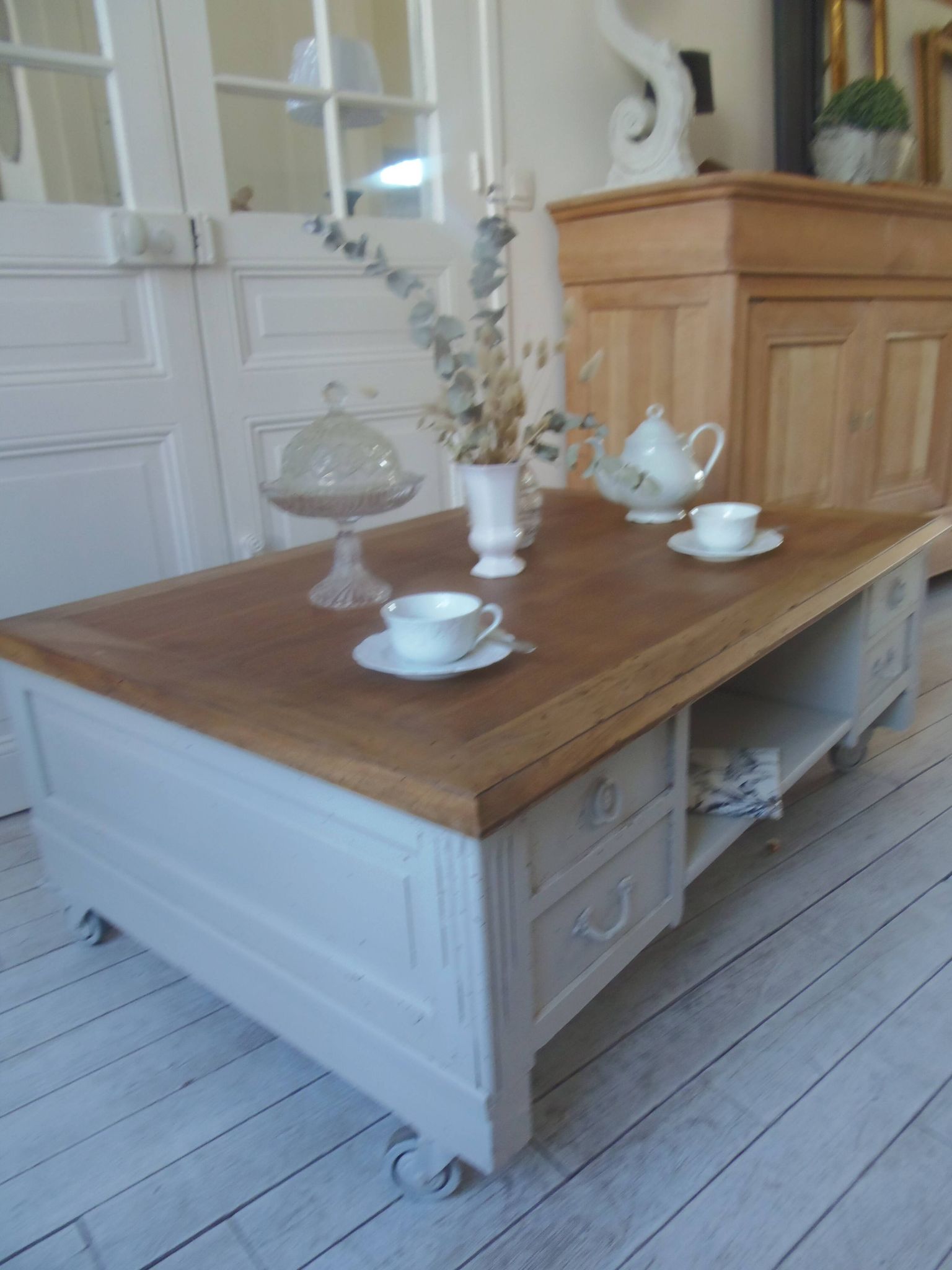 Coffee table on casters, made from an old desk, pearl gray base and belt.