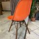 A vintage 70s Eames Herman Miller DSW Fiber Red Orange Dowel Walnut Chair