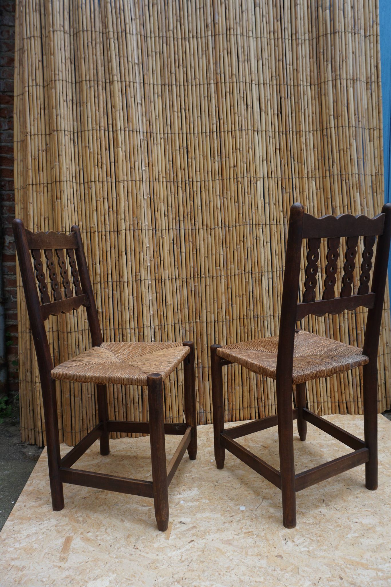 Pair of antique straw-seated farm chairs