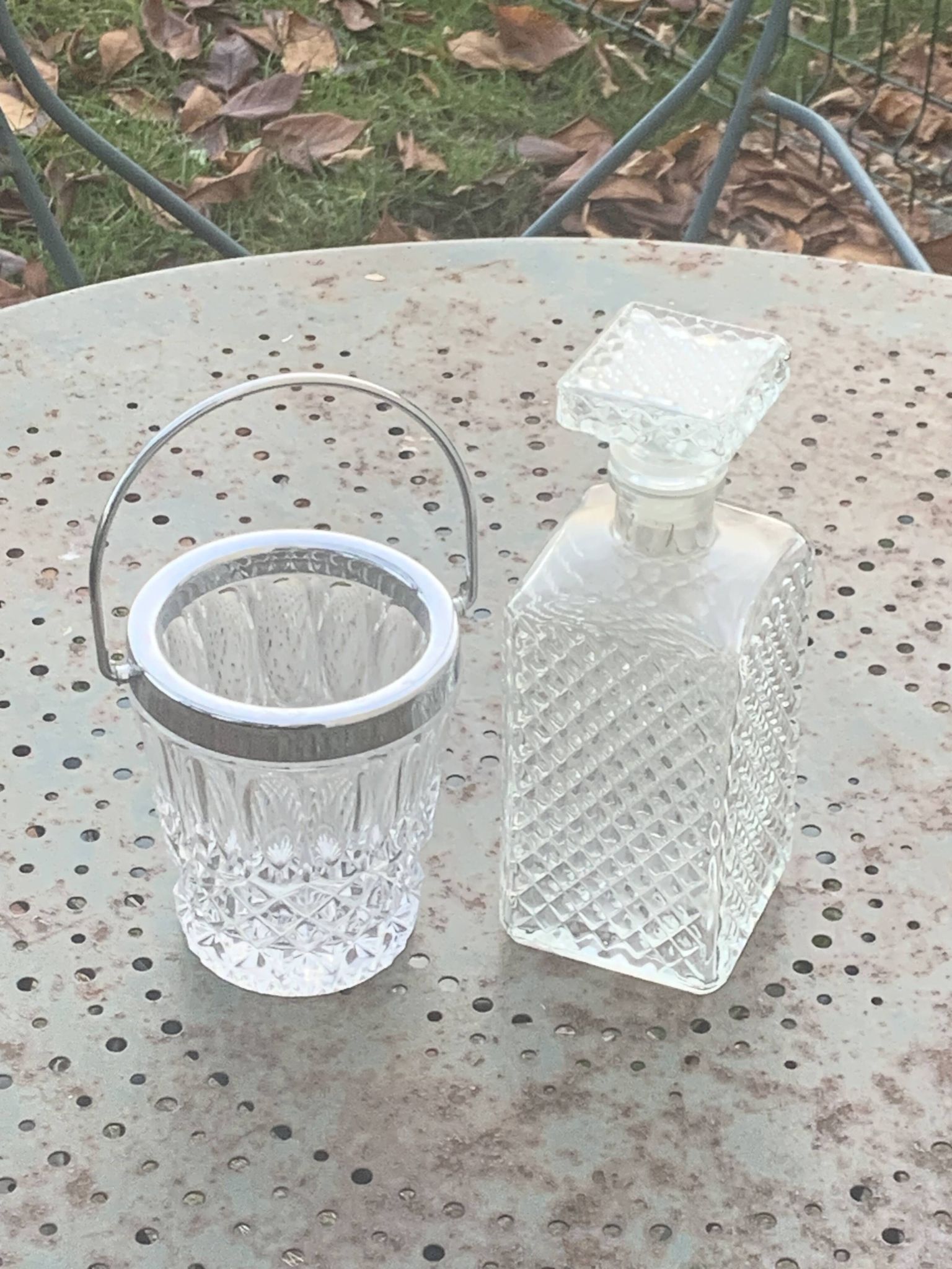 Whiskey carafe and ice bucket in transparent glass and silver-colored metal handle