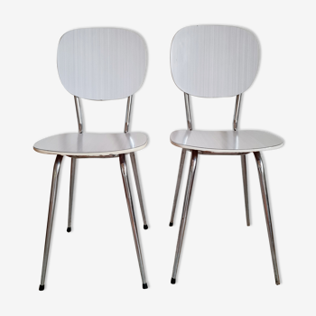 Pair of white formica chairs and stripes