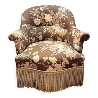 Fauteuil crapaud tissu imprimé franges début XXème