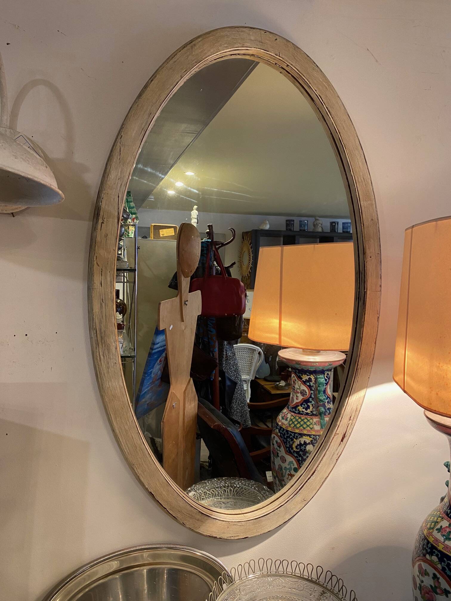Large old oval mirror with beige patina wooden frame early 20th century