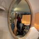 Large old oval mirror with beige patina wooden frame early 20th century
