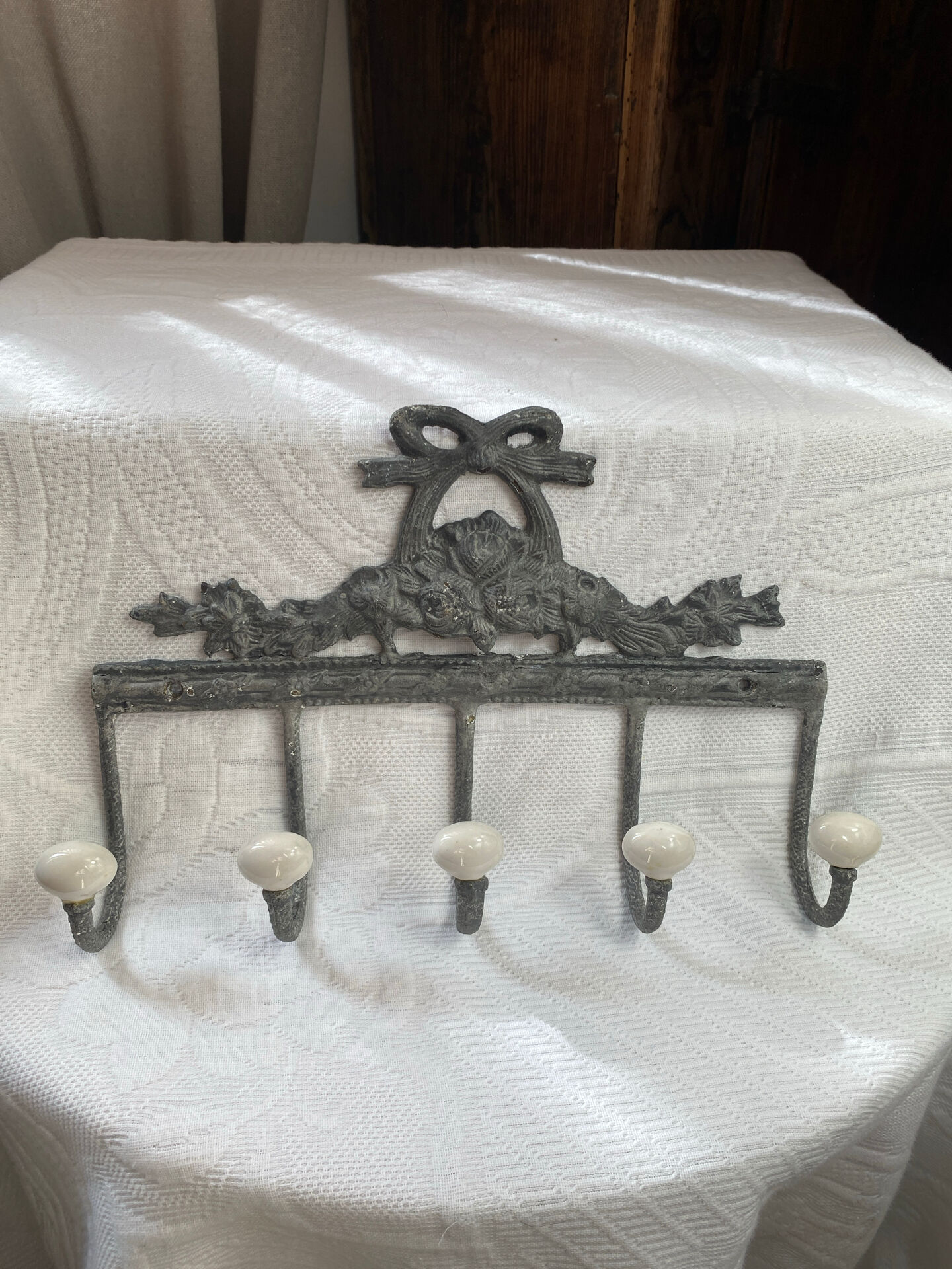 Patinated metal wall bracket and porcelain