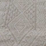 Hand-woven rug in natural wool
