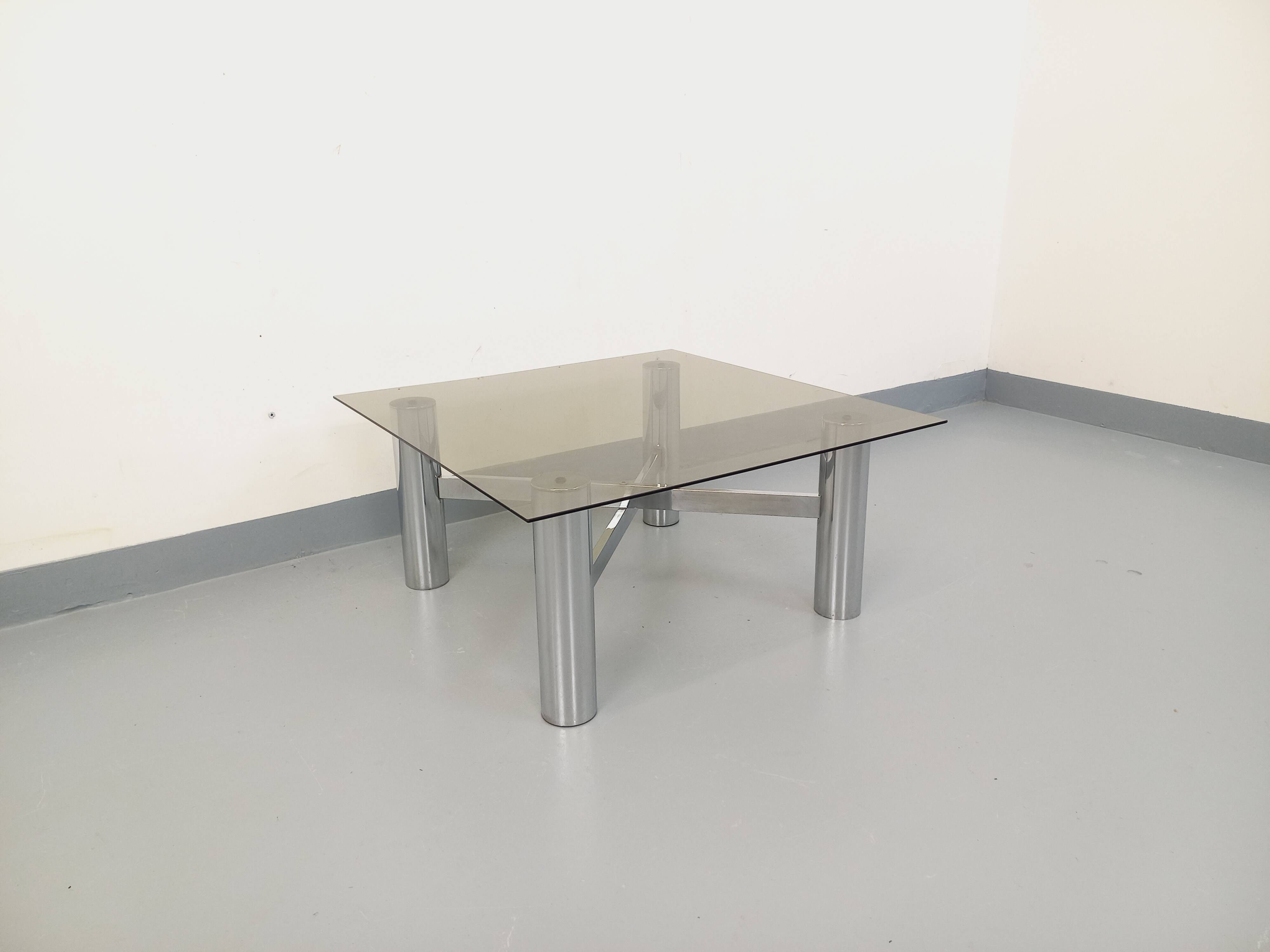 Square Italian vintage Space Age coffee table in smoked glass and metal.