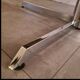 Blackened wooden dining table and chrome foot with integrated butterfly extension