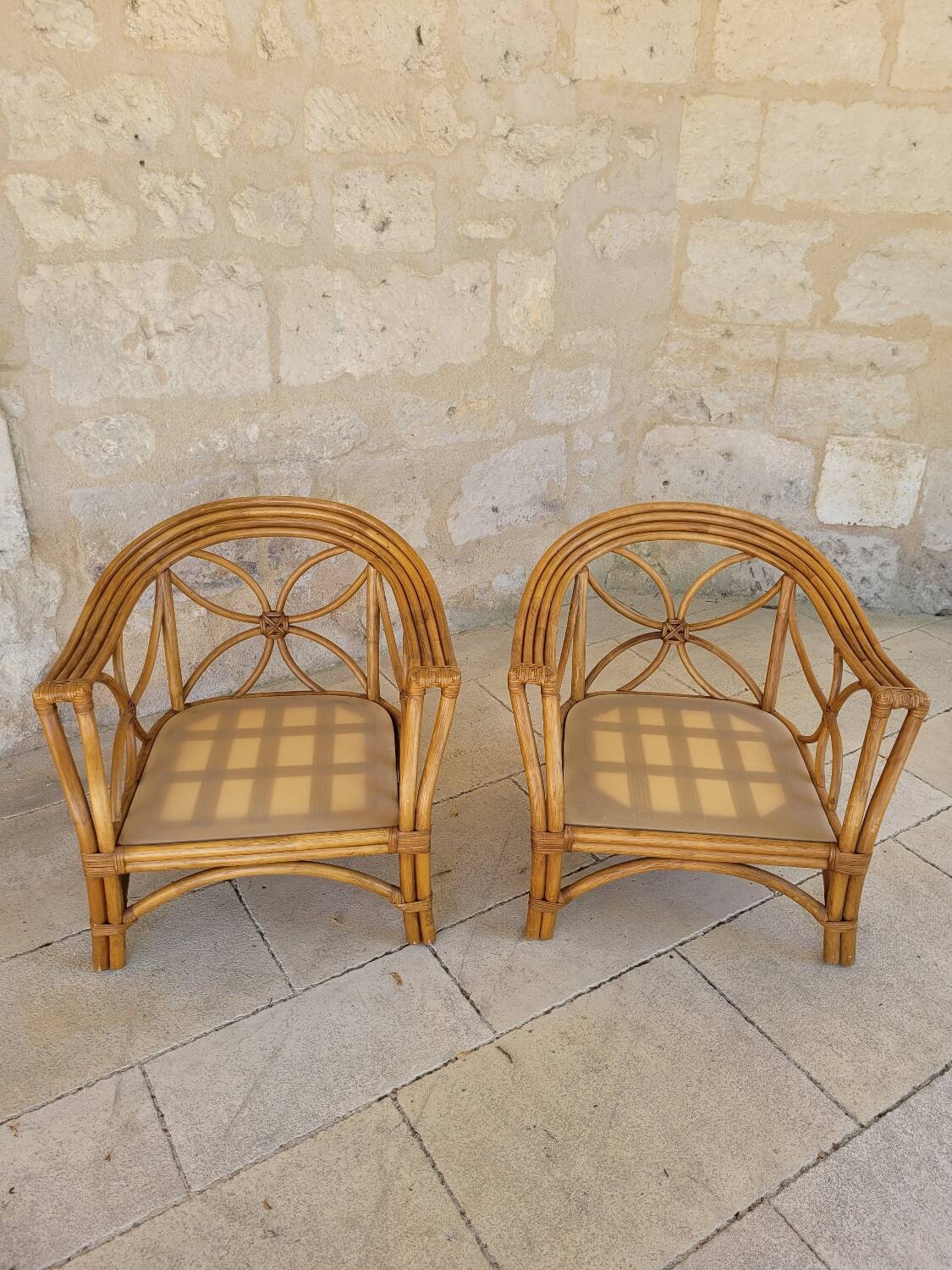 Two large rattan armchairs