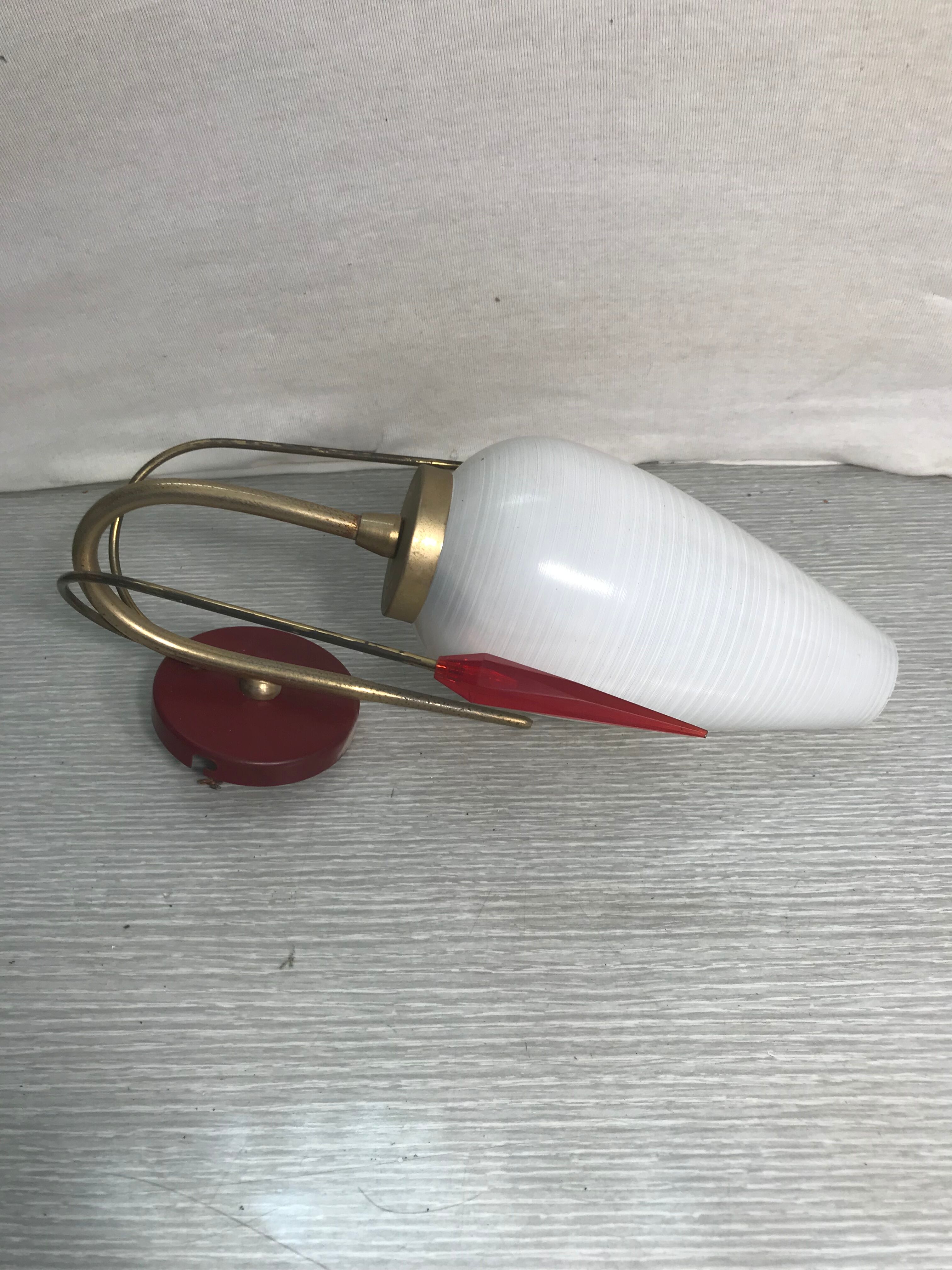 Golden metal wall sconce with red and white opaline reflectors