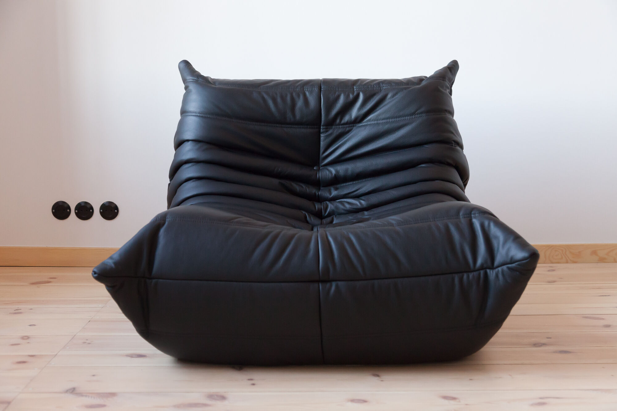 Armchair and ottoman in black leather model designed by Michel Ducaroy 1973