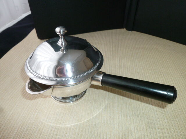 Covered saucepan with silver metal tail