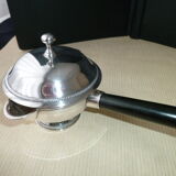 Covered saucepan with silver metal tail