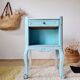 Small vintage bedside table in azure blue patina.