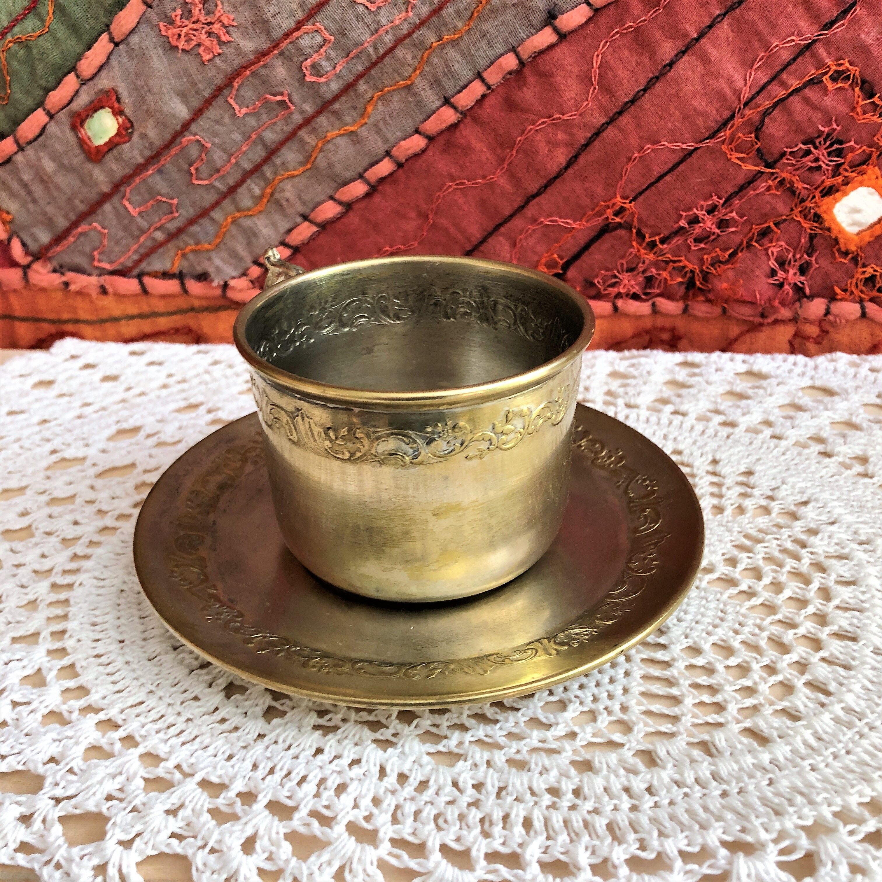 Silver metal cup and saucer