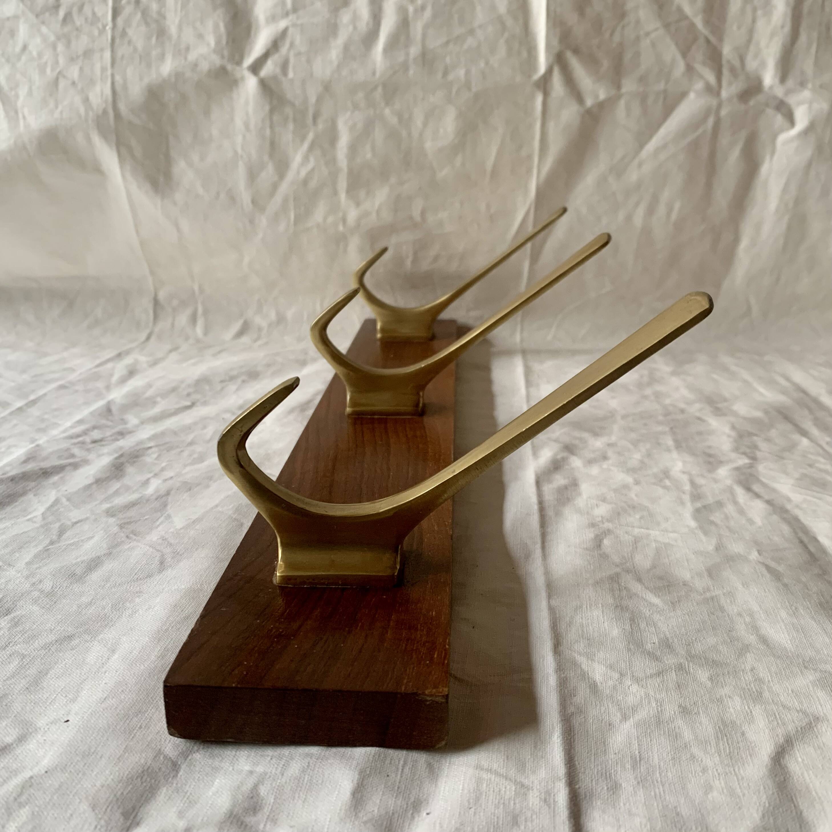 Vintage wooden wall-mounted coat rack with 3 golden cast aluminum hooks