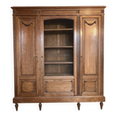 Three-door glass display cabinet with a grille in the Louis XVI style, antique and decorated.