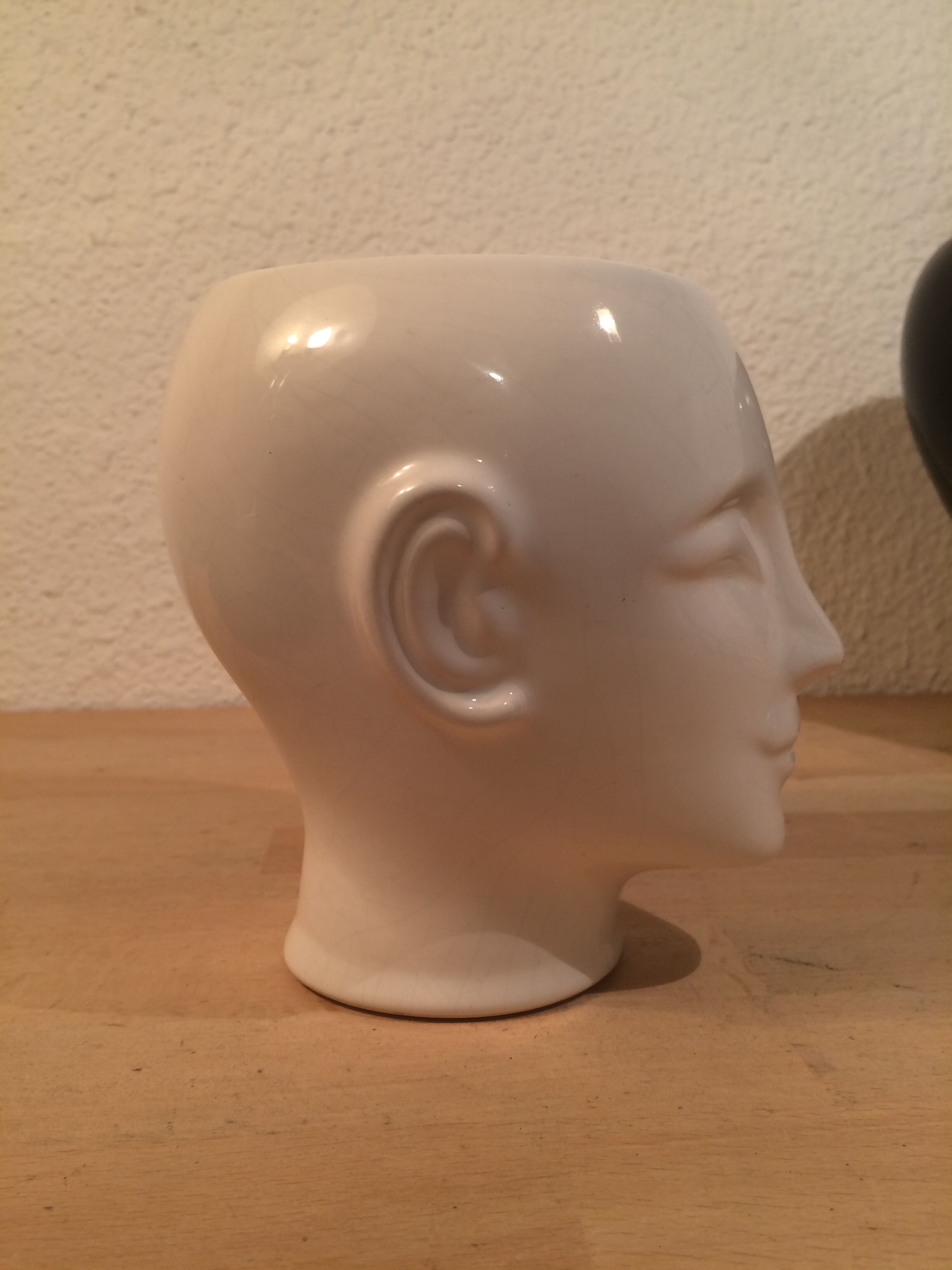 2 black and white ceramic head vases, face