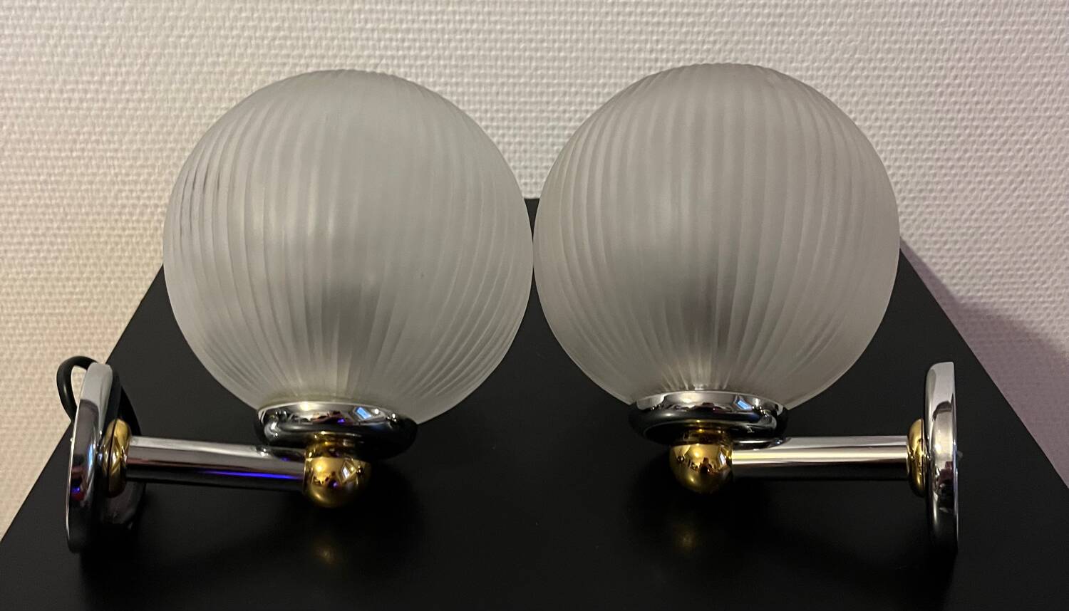 Pair of Inda metal and chiseled glass wall lights