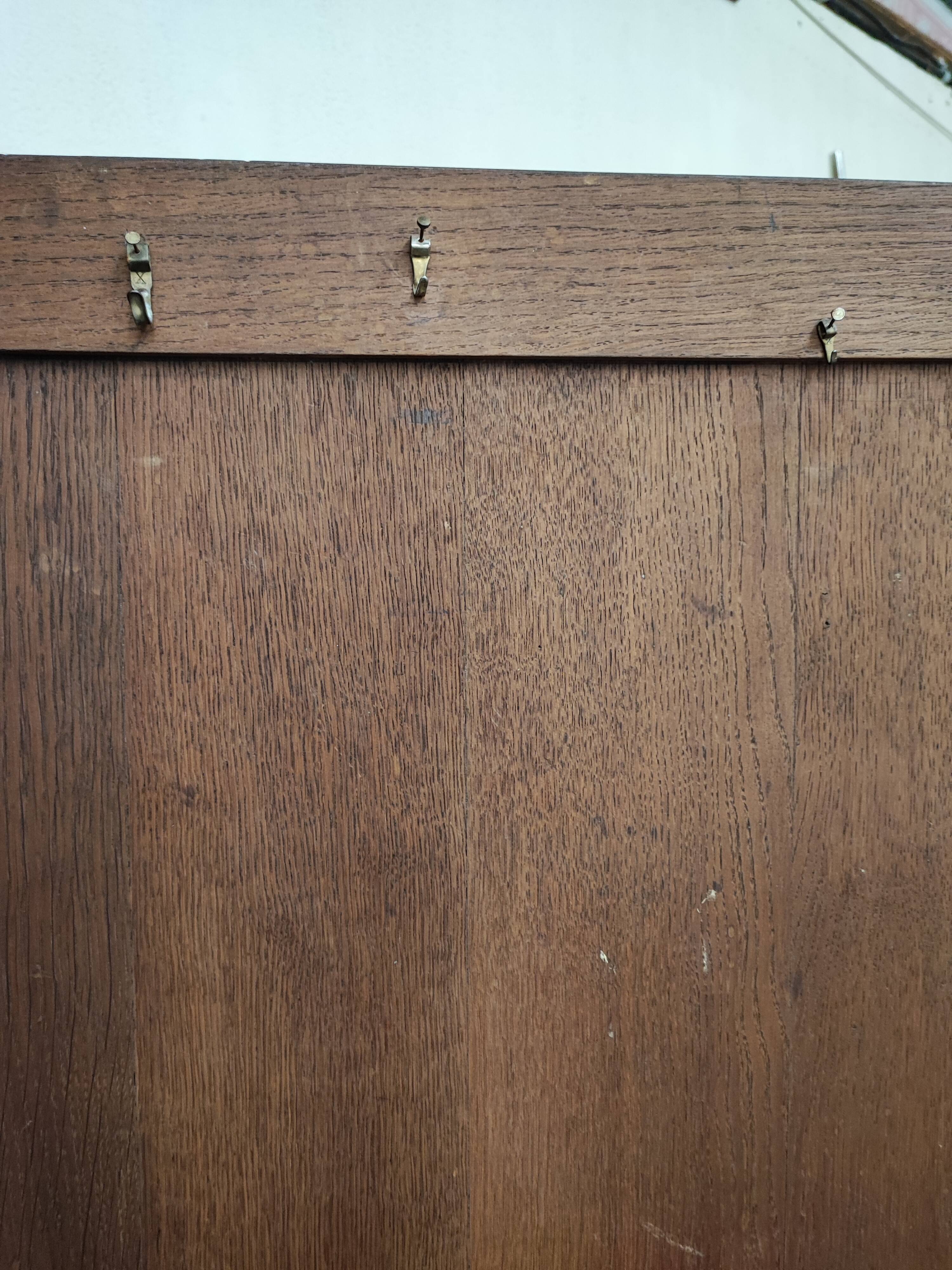 Bonnetière man standing cabinet a door