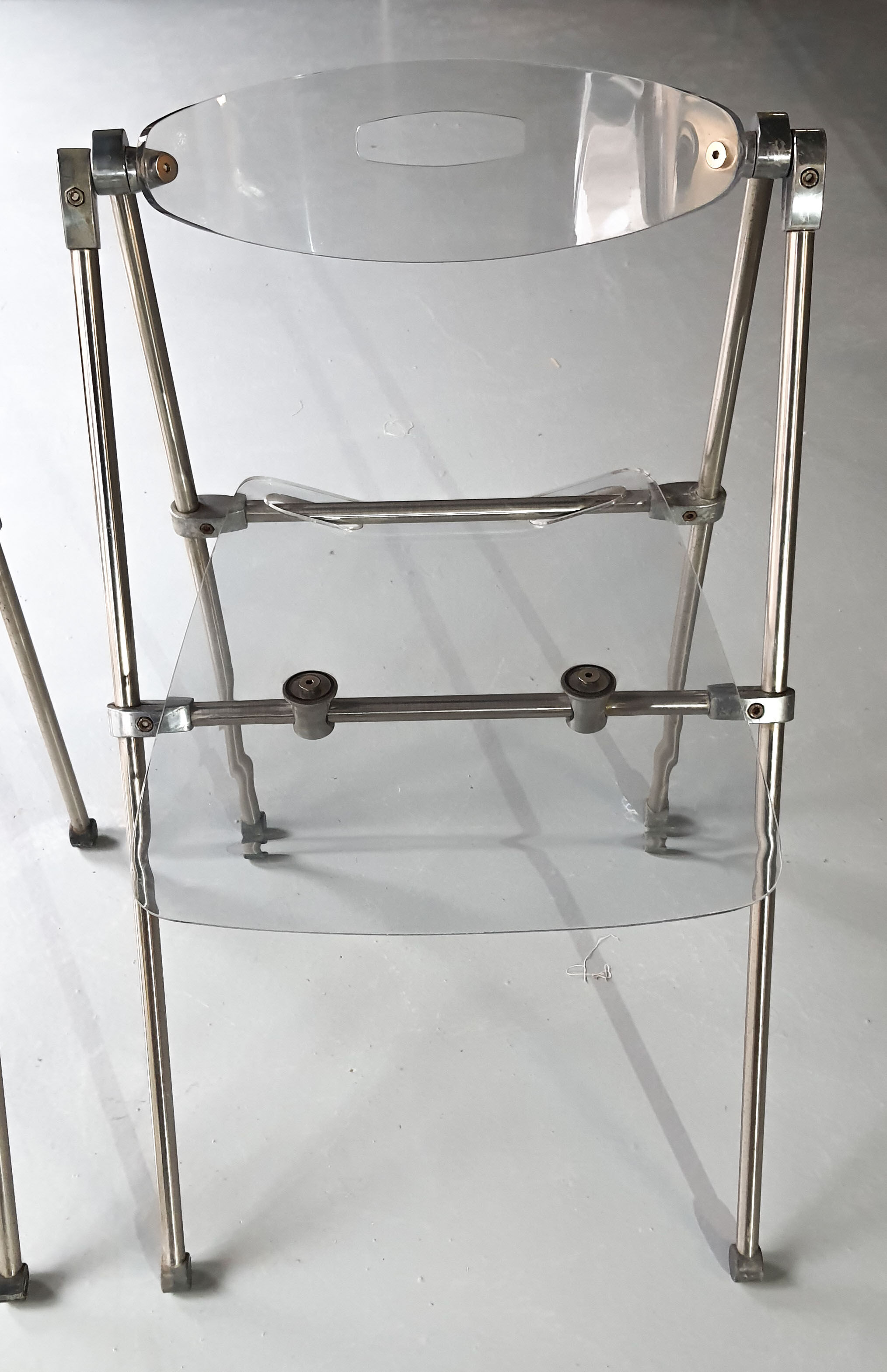 Pair of modern folding chairs in plexiglass