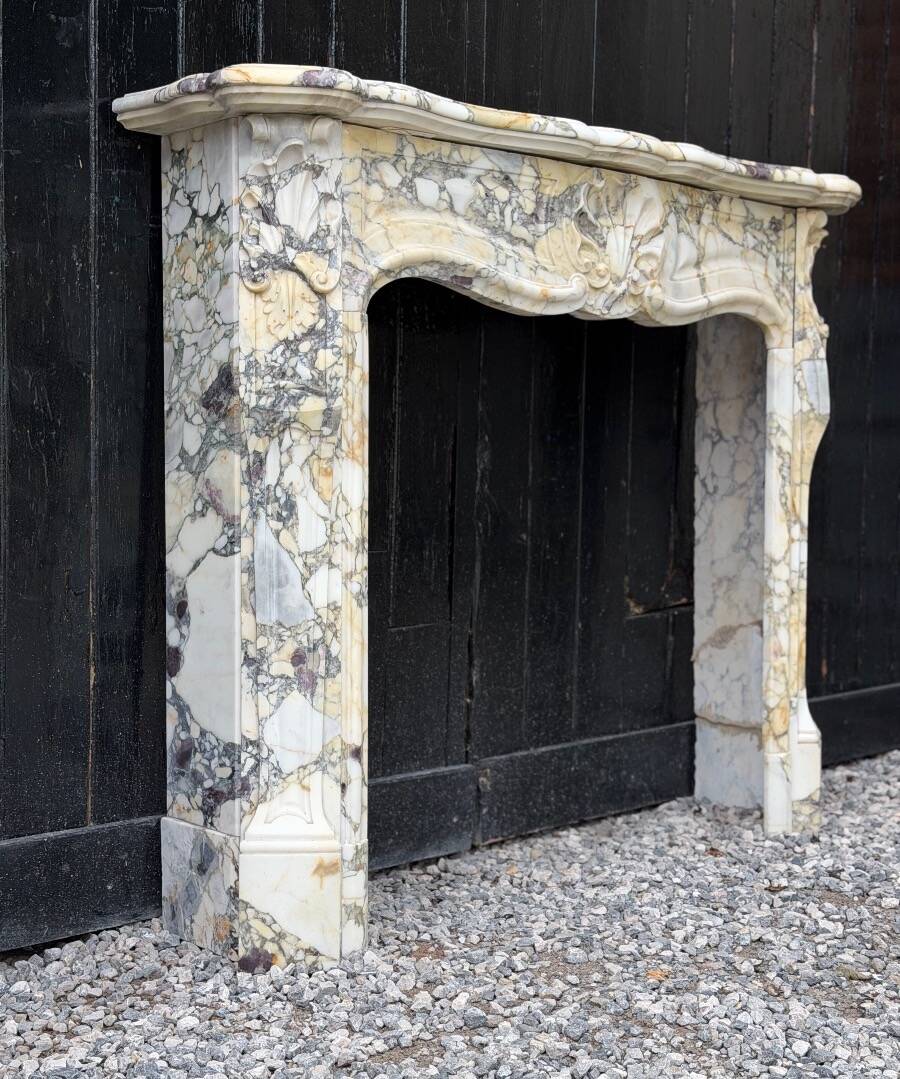 Louis XV style fireplace in purple breccia marble, circa 1880.