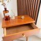 Vintage bedside table with tapered legs.