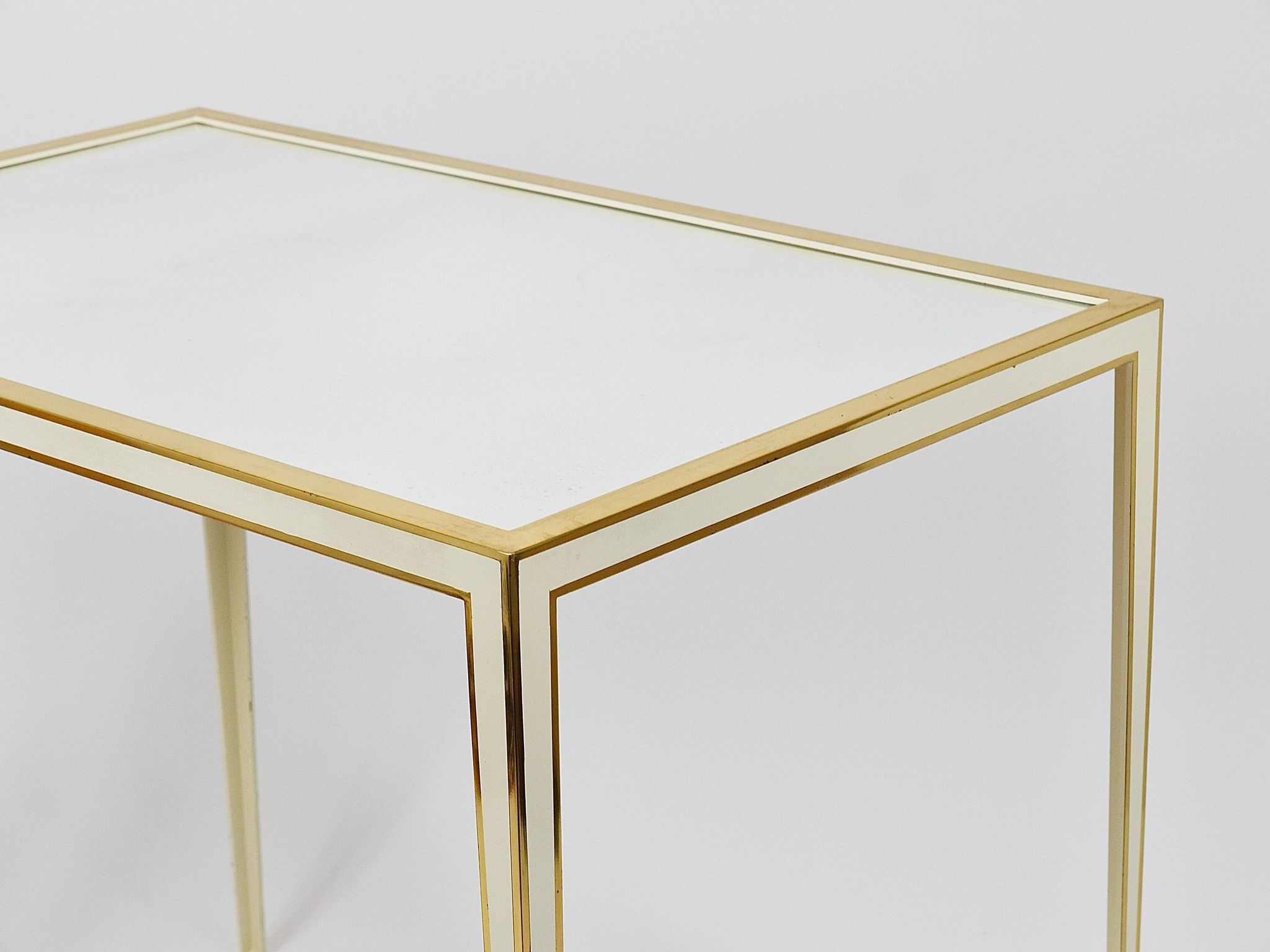 A pair of brass and white mirror tables from Vereinigte Werkstätten, Germany, 1970s.