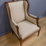 Wingback armchair in walnut, Louis XVI style – late 19th century