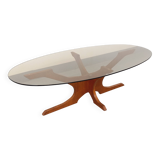 Vintage Hugues Poignant oval coffee table in teak and smoked glass from the 1970s