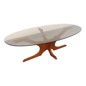 Vintage Hugues Poignant oval coffee table in teak and smoked glass from the 1970s