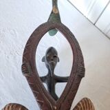 A large Senufo mask made of colored wood, decorated with an anthropomorphic figure