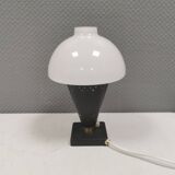 Small stylish table lamp with perforations and milky white opal glass shade