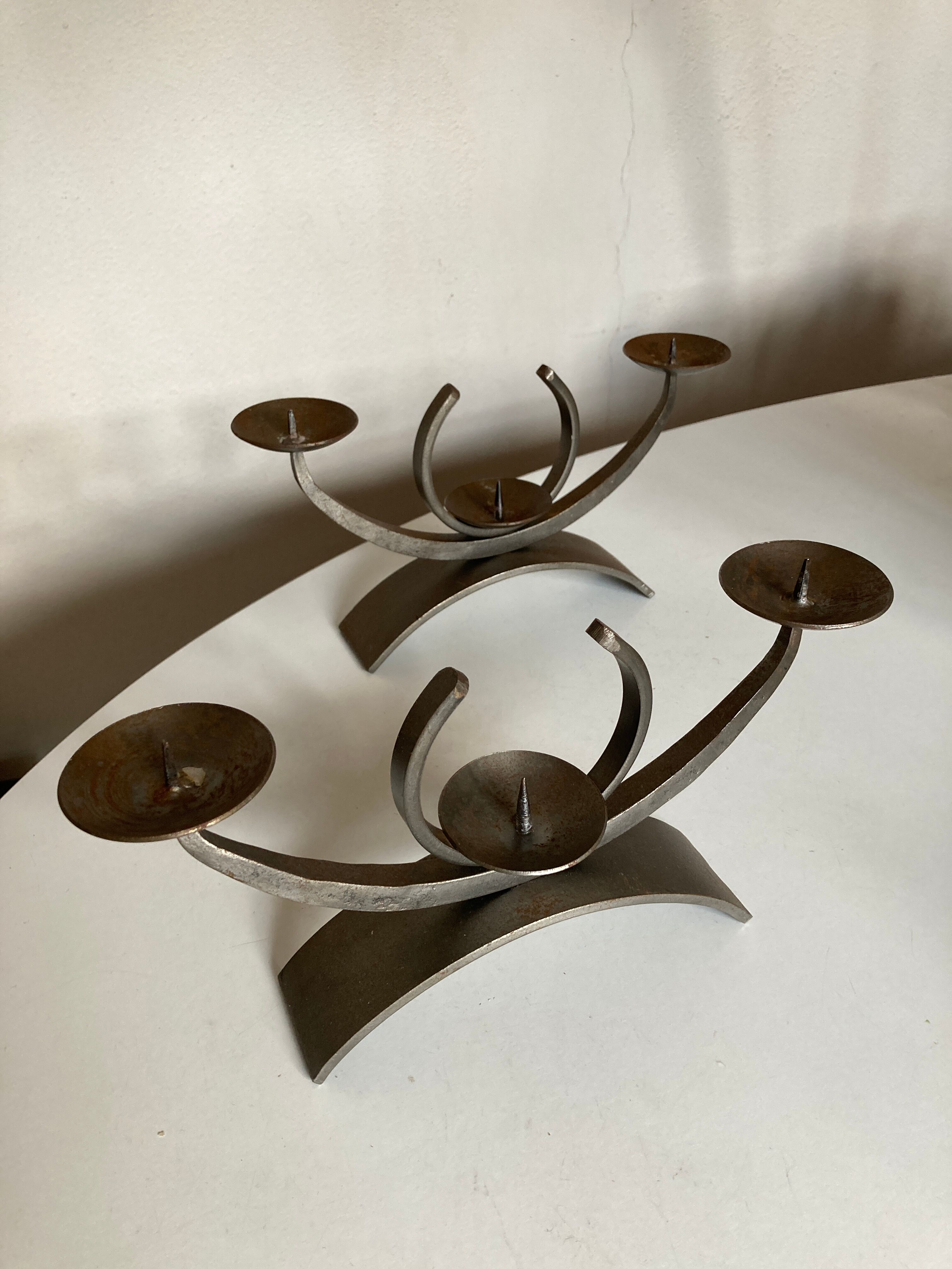 Pair of modernist candlesticks in beaten iron 1970