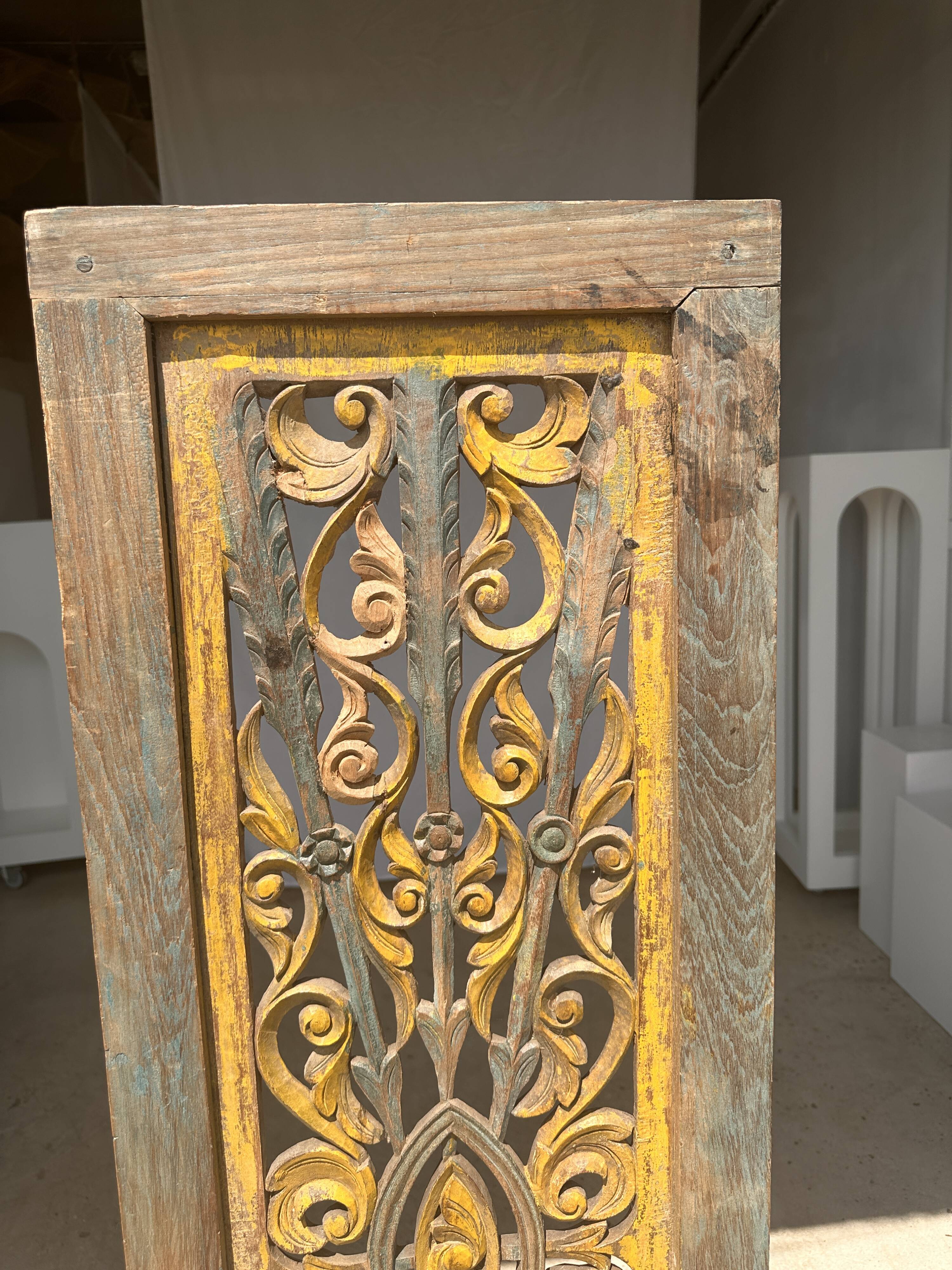 Rectangular Indonesian construction element with blue and yellow plant in carved wood