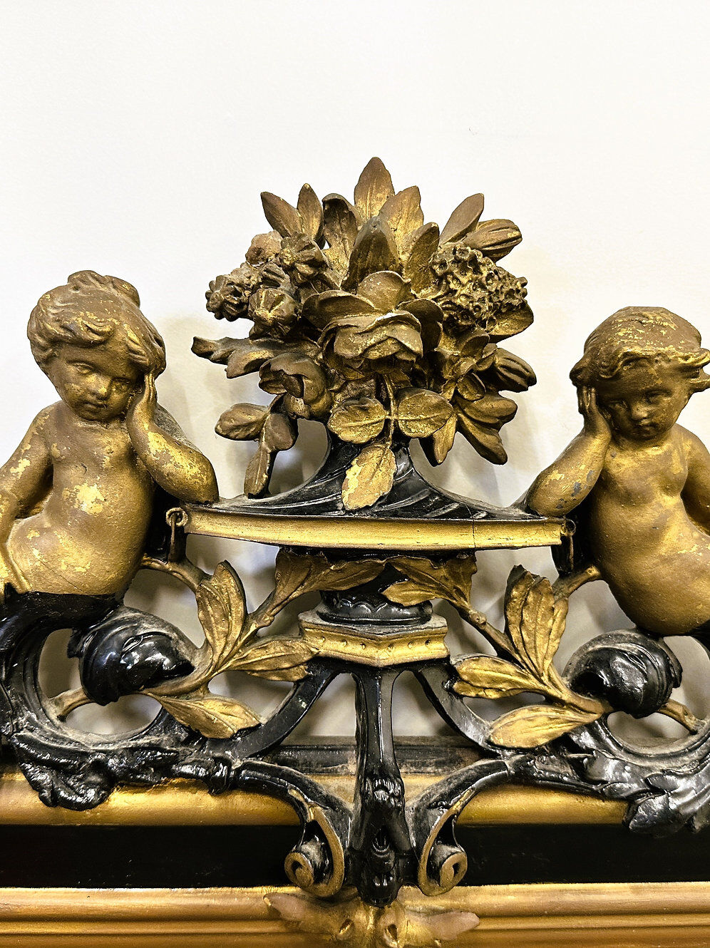Antique 1800s black and gold mirror with cupid, France 1800s.