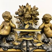 Antique 1800s black and gold mirror with cupid, France 1800s.